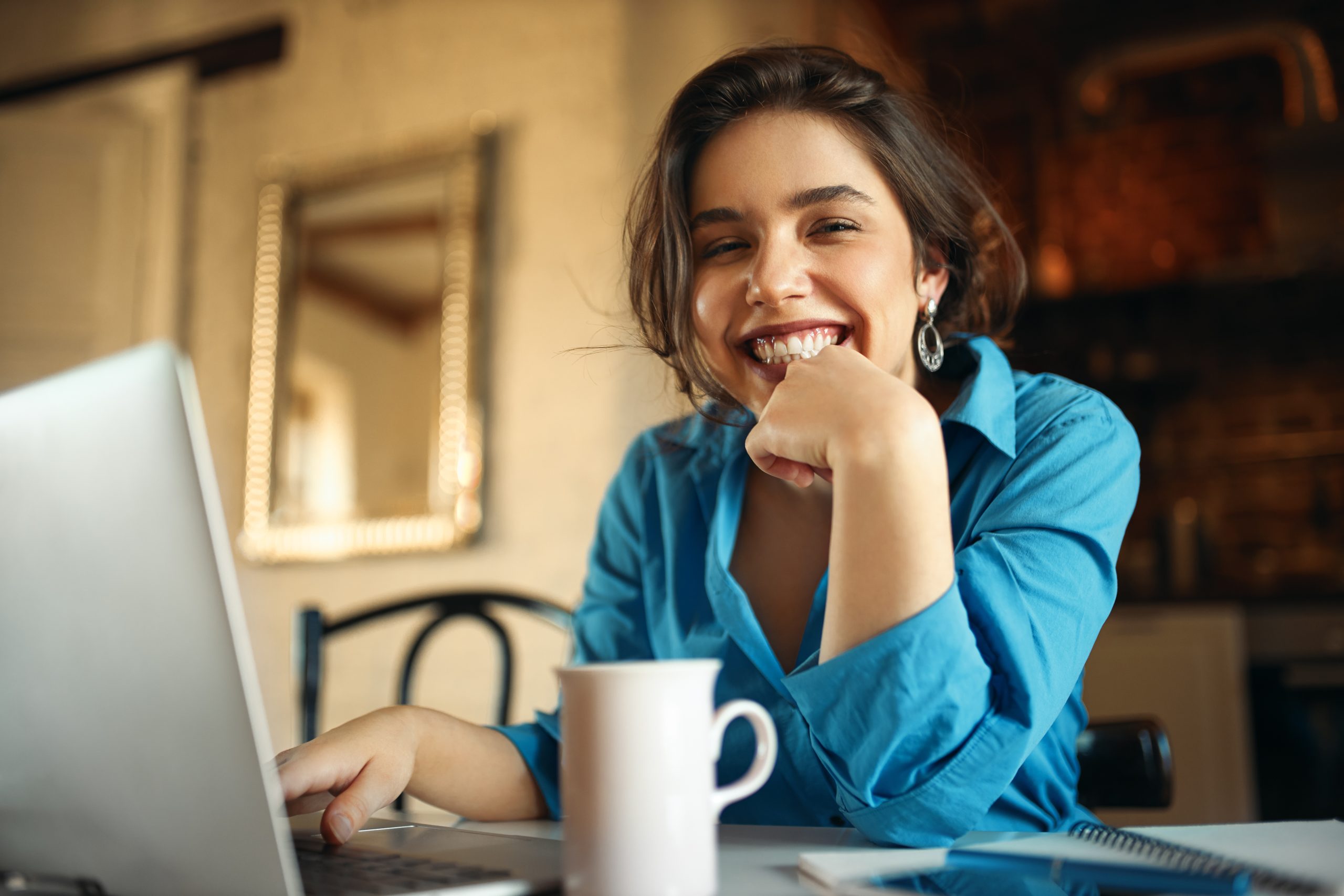 cheerful-attractive-young-woman-enjoying-distant-work-sitting-desk-using-portable-computer-drinking-coffee-pretty-female-blogger-working-from-home-uploading-video-her-channel-smiling cheerful-attractive-young-woman-enjoying-distant-work-sitting-desk-using-portable-computer-drinking-coffee-pretty-female-blogger-working-from-home-uploading-video-her-channel-smiling